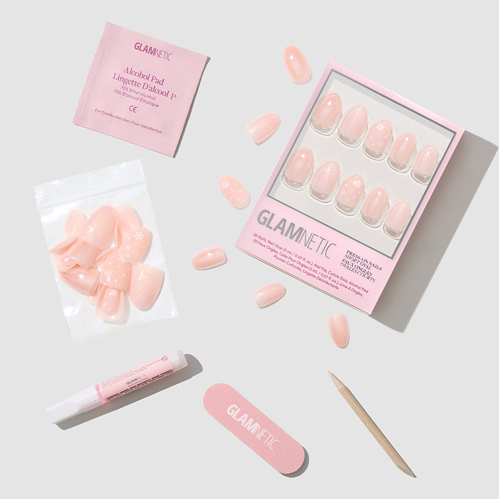 Glamnetic Prosecco Pearl short oval press-on nails shown with a pink storage box, alcohol pad, nail glue, nail file, and wooden cuticle pusher. - Product image