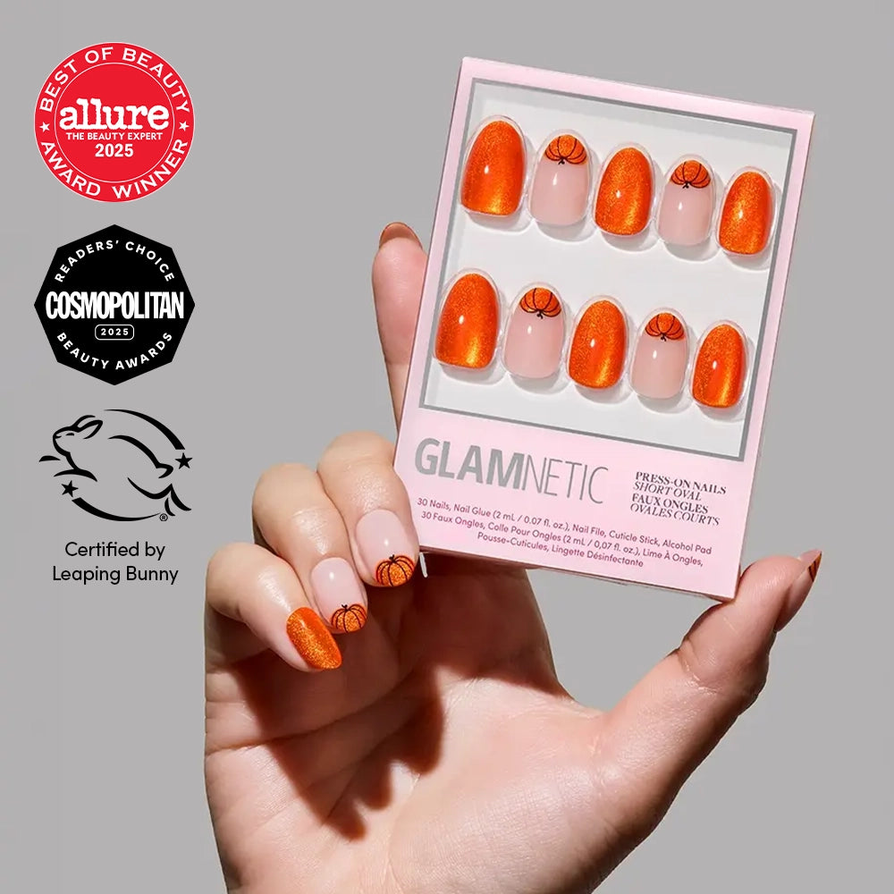 A hand holds a box of glamnetic Pumpkin Patch Press-On Nails with an orange basketball design. Allure 2025, Cosmopolitan, and Leaping Bunny logos are displayed to the left. - Product image