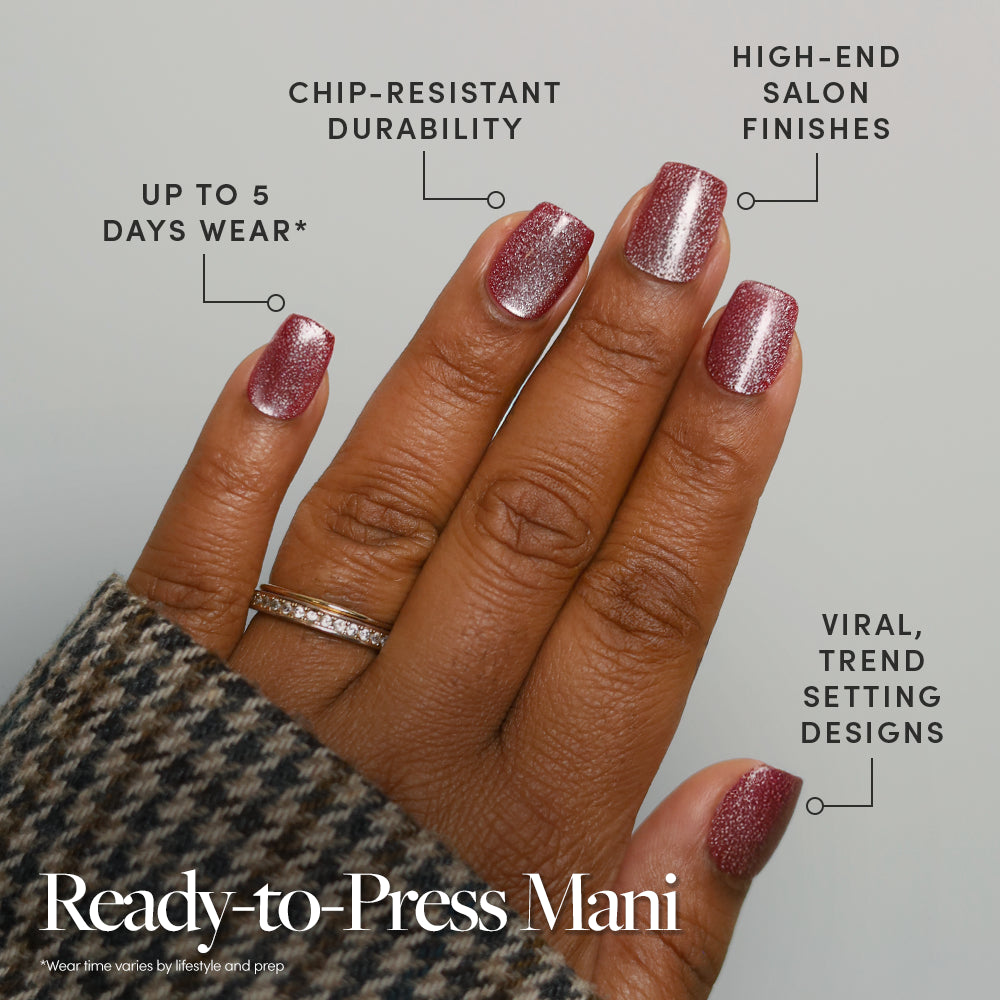 A hand with sparkling pink Red Allure press-on nails from glamnetic is shown, featuring chip-resistant durability, up to 5 days of wear, high-end salon finish, and trendy style. The text reads: “Ready-to-Press Mani”—no glue needed for a quick glam look. - Product image