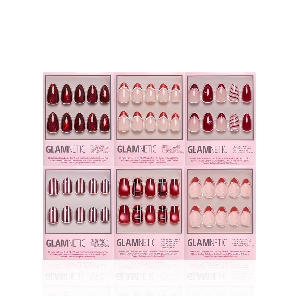 Red-y for the Holidays - Six boxes of Glamnetic Red-y for the Holidays nail sets in various shades of red and white, including solid, glitter, and French tip patterns.
