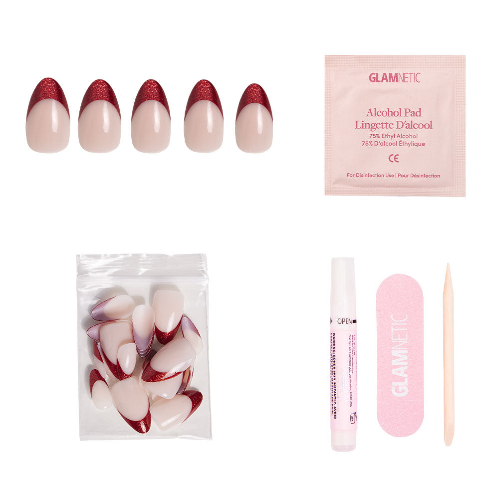 The glamnetic Red Affair press-on nail set features five short almond nails with red tips, some with glitter French accents, plus extra nails, nail glue, a pink file, alcohol pad, and cuticle stick—all on a white background. - Product image