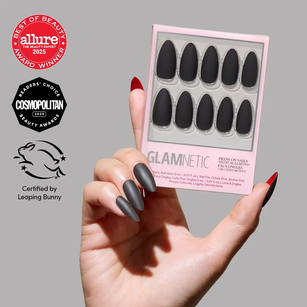 A hand with long, Red Bottom nails by glamnetic holds a box of Press-On Nails. Award logos from Allure, Cosmopolitan, and Leaping Bunny are shown on a gray background. - Product image