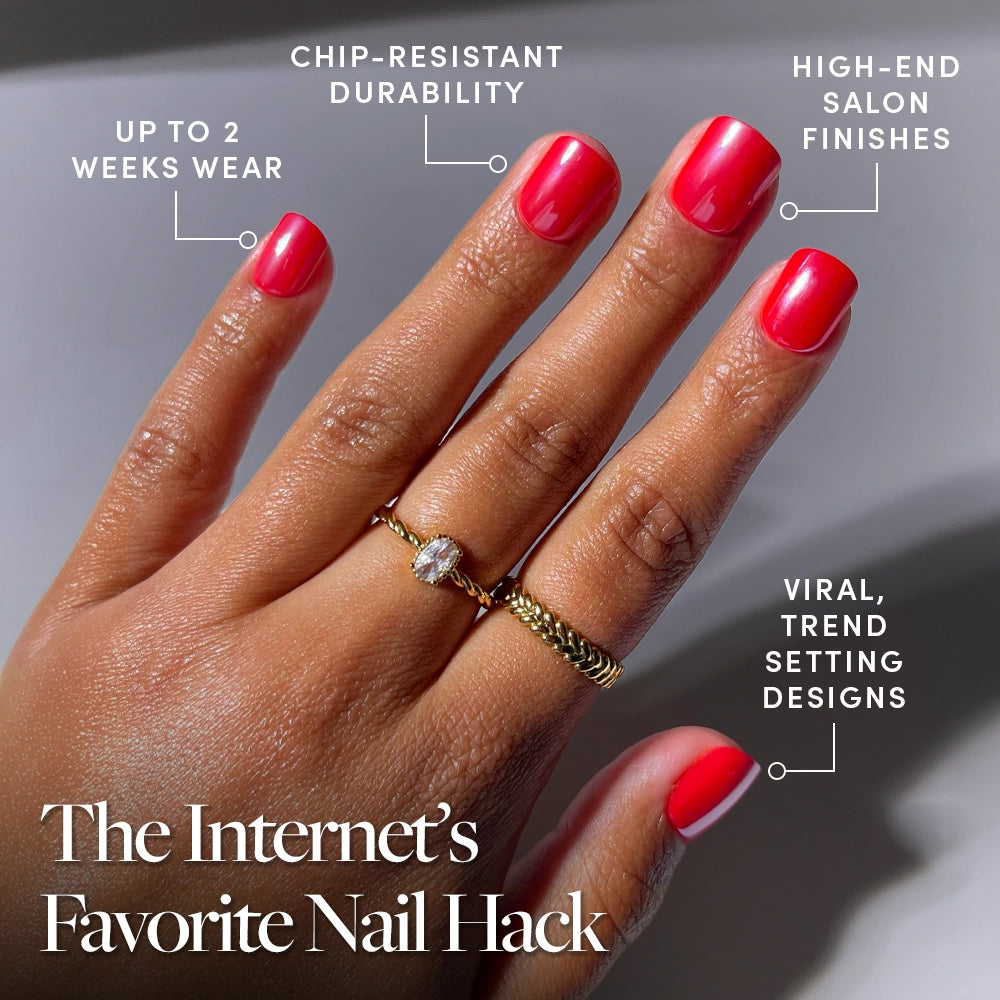 A hand with glossy, bright red "Red Legacy" press-on nails by glamnetic is shown, wearing two gold rings. Text highlights up to 2 weeks' wear, chip-resistant durability, salon-quality finish, and trendy designs—even for short nails. - Product image