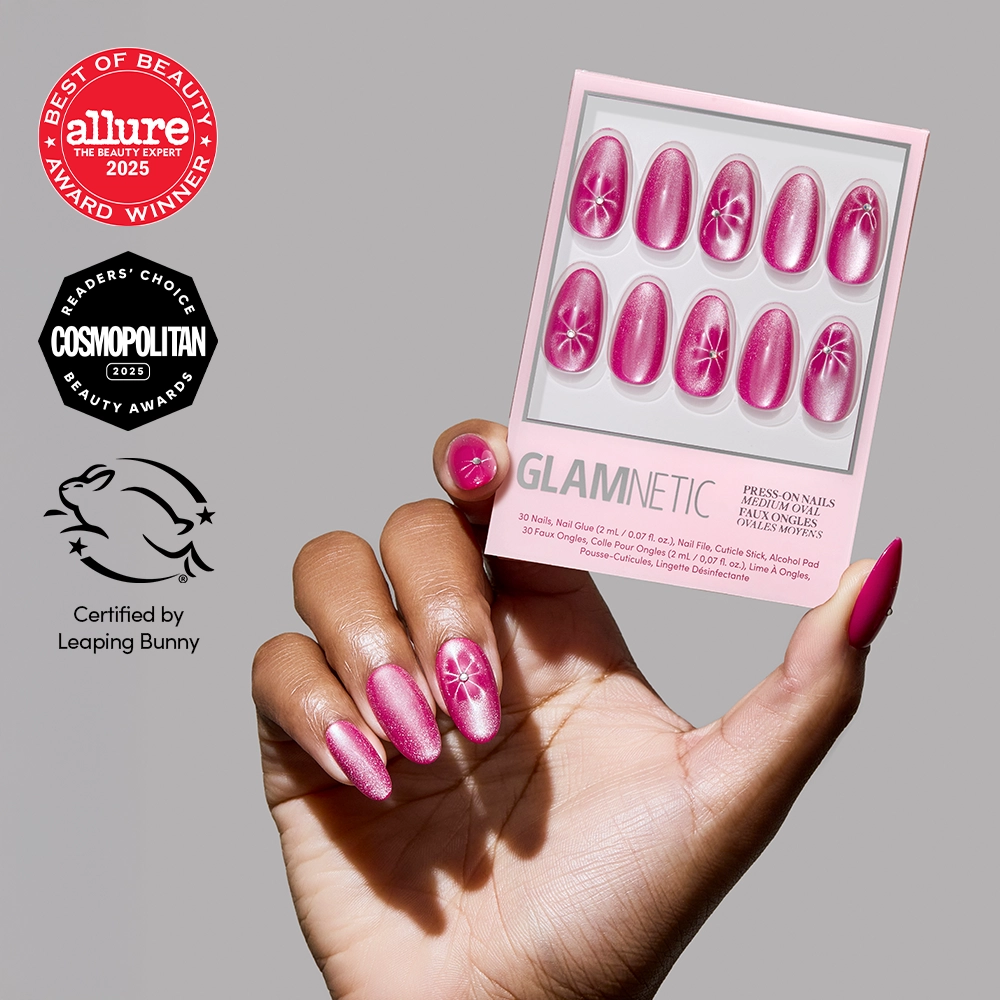 A hand with pink, shimmery Rosy Siren press-on nails featuring a floral design holds a glamnetic box. Beauty award badges and the Leaping Bunny cruelty-free logo appear on the left.