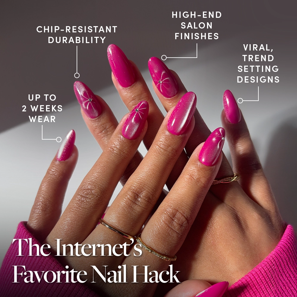 A close-up of hands wearing glamnetic's Rosy Siren nails in magenta rose with white floral art. Enjoy chip-resistant durability, up to 2 weeks of wear, salon-quality finish, and a viral trendsetting design. - Product image