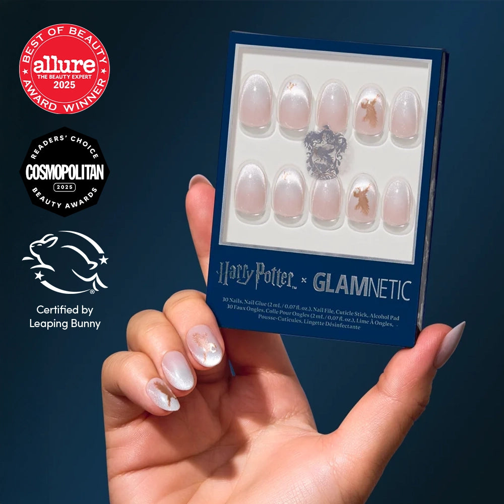 A hand holds a box of Rowena Ravenclaw™ nail set press-ons, showcasing the matching short oval design on the wearer’s nails.