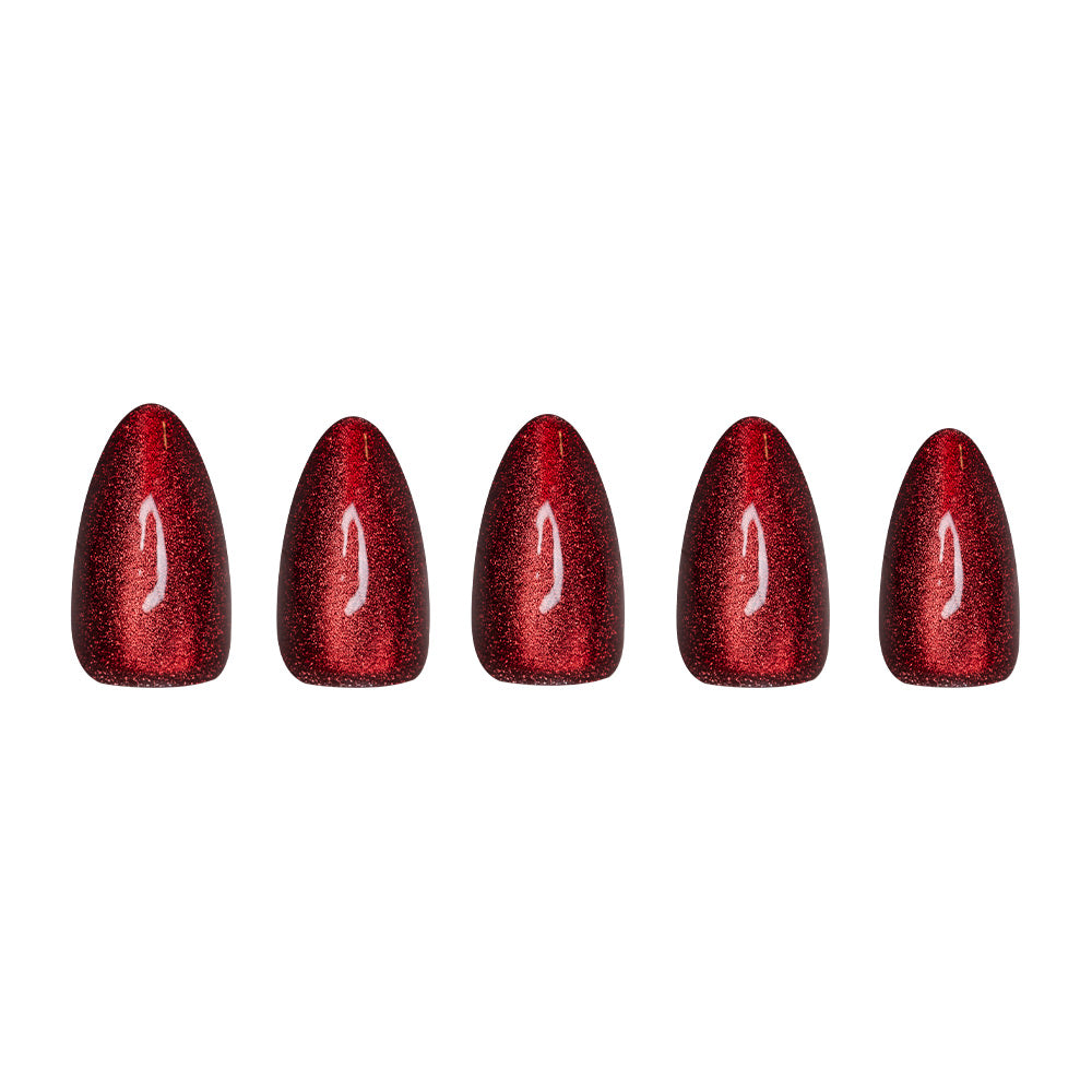 Five short almond artificial nails from glamnetic’s Ruby Slipper set, featuring a glossy, glittery red finish, are displayed in a row on a white background. - Product image