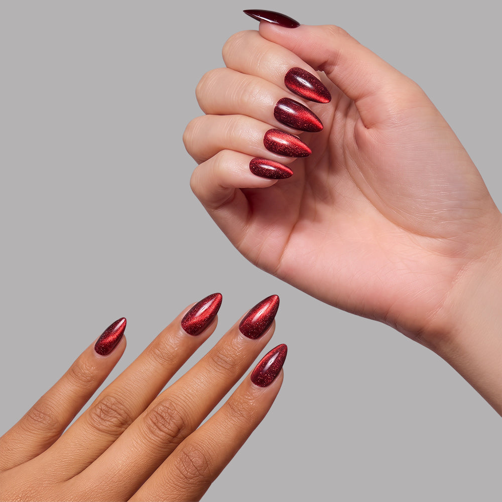 Ruby Slipper - Two hands showing short almond nails in a shimmering, deep red Glamnetic Ruby Slipper cat-eye finish.