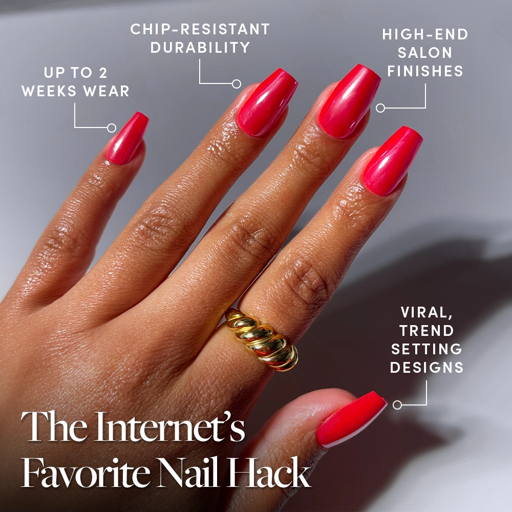 A hand with long, glossy Runway Red press-on nails by glamnetic is shown, featuring up to 2 weeks wear, chip-resistant durability, salon-quality finish, and viral designs. The hand wears a chunky gold ring. - Product image
