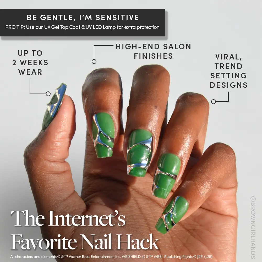 A hand showcases glamnetic’s Salazar Slytherin™ velvet green coffin nails with blue, white, and silver abstract art. Enjoy high-end salon finishes, viral trend-setting designs, and up to 2 weeks of wear. - Product image