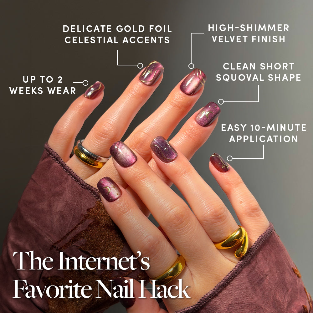 Two hands display Scarlet Spell, glamnetic’s shiny mauve press-on nails with gold foil accents. The image highlights their short squoval shape, velvet-like shimmer, easy 10-minute application, and up to 2 weeks of wear. Both hands are accessorized with gold rings. Text reads: The Internet’s Favorite Nail Hack. - Product image