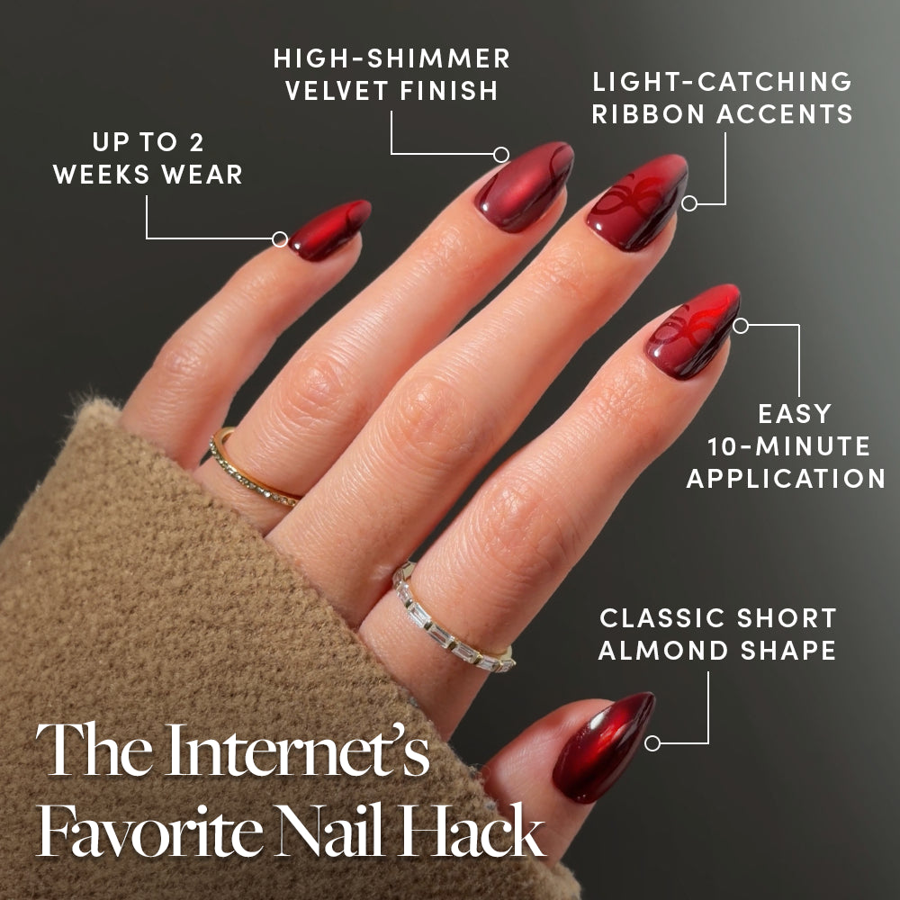 Scarlet Ribbons glamnetic press-on nails in a short, almond-shaped red design with velvet-effect ribbon accents, a high-shimmer finish, and light-catching details. - Product image