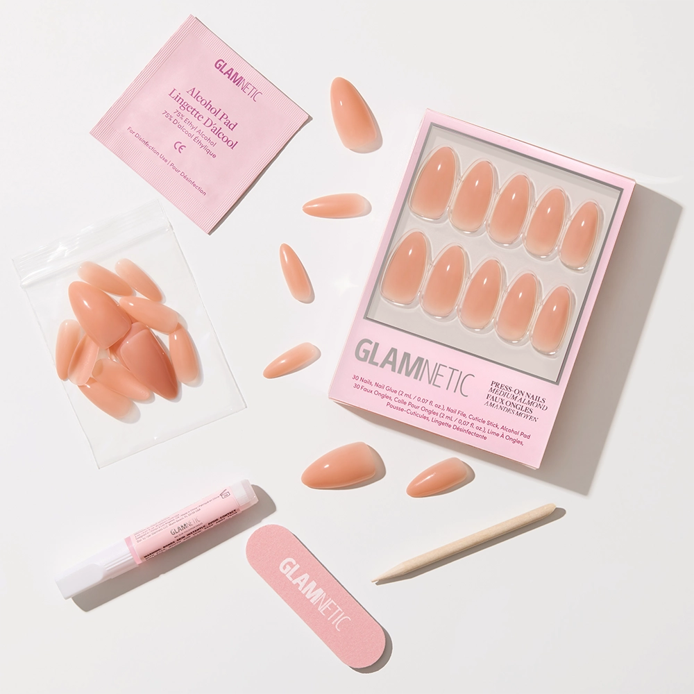 The glamnetic Sheer Peach press-on nails feature a peachy nude, semi-transparent jelly finish and come with a nail file, cuticle stick, glue, alcohol pad, and extra nails, all displayed on a white background. - Product image