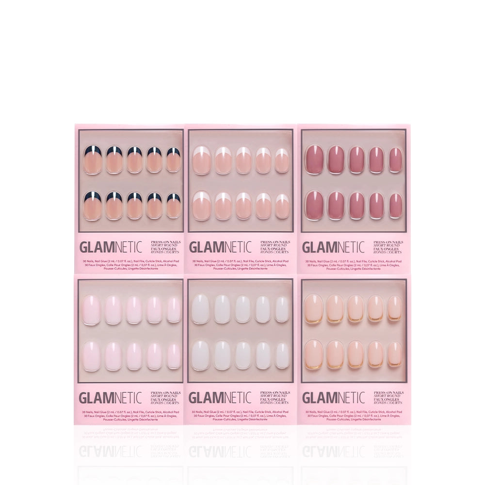 Six boxes of glamnetic Short Round Icons press-on nails, featuring neutral pink, nude, and white French tip designs, are arranged in two rows of three against a white background. - Product image