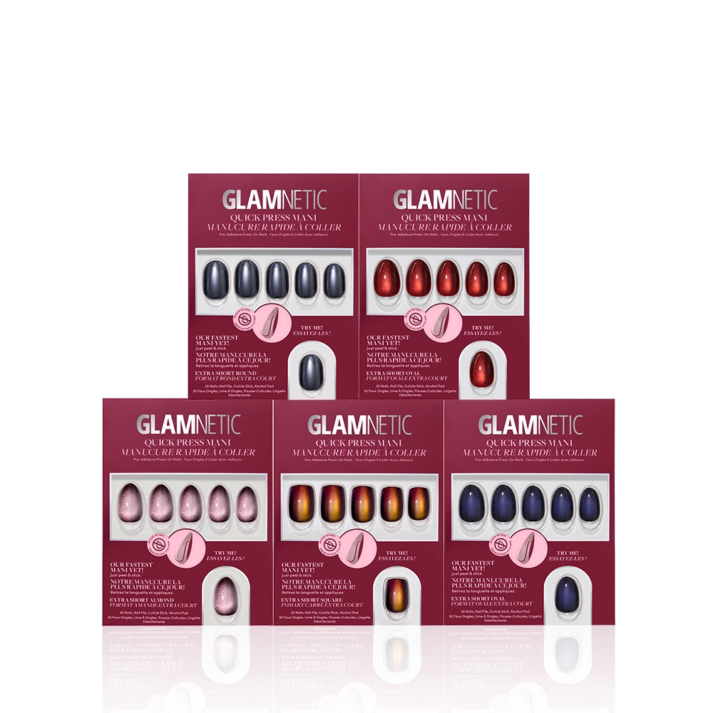 Five boxes of glamnetic Short Spells press-on nails in various colors are arranged in a pyramid shape. Each box displays a set of nails in shades of red, purple, and metallic hues, with product details printed in white and pink text. - Product image