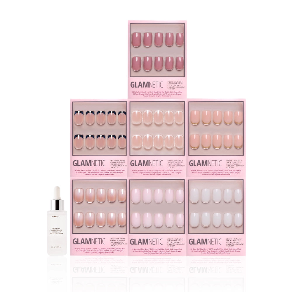 Seven boxes of glamnetic Short Squoval Icons press-on nails in pink and nude are stacked in a pyramid, with a glamnetic cuticle oil dropper bottle to the left, all set against a white background. - Product image