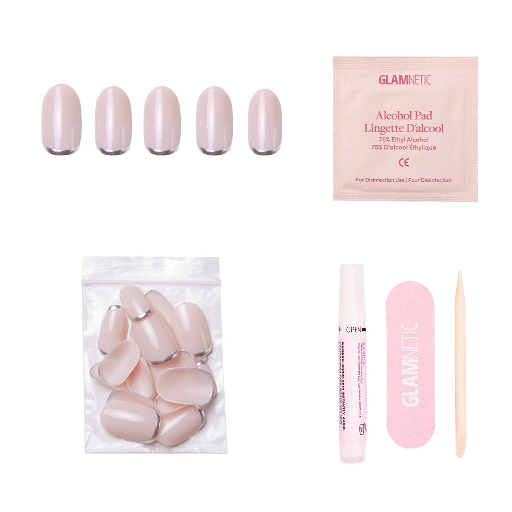 The glamnetic Silver Belle press-on nail kit includes five short round sample nails, nude nail tips, an alcohol pad, nail glue, a pink file, and a wooden cuticle stick—all reusable and displayed on a white background. - Product image