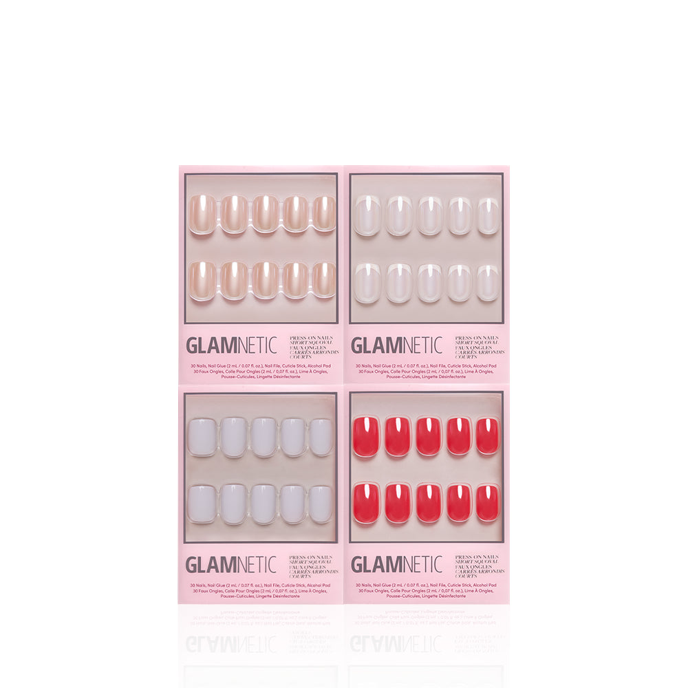 Four pink boxes of glamnetic SoHo Squovals press-on nails are arranged in a square. Each set features short squoval press-on nails in nude, light pink, pale gray, and bright red shades, displayed clearly in their boxes against a white background. - Product image