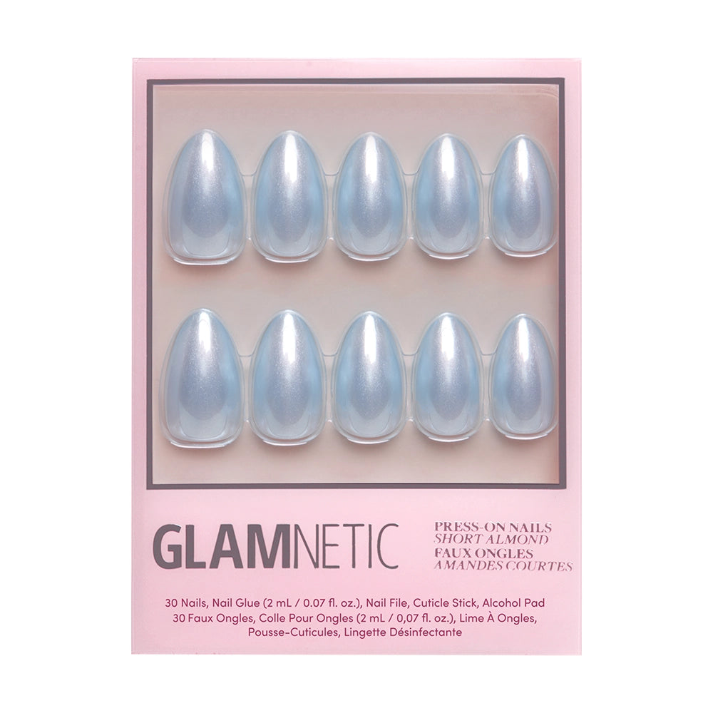 A pink box labeled glamnetic displays 10 shiny, salon-quality, baby blue short almond nails from the Something Blue collection. Packaging text lists included accessories and product details.