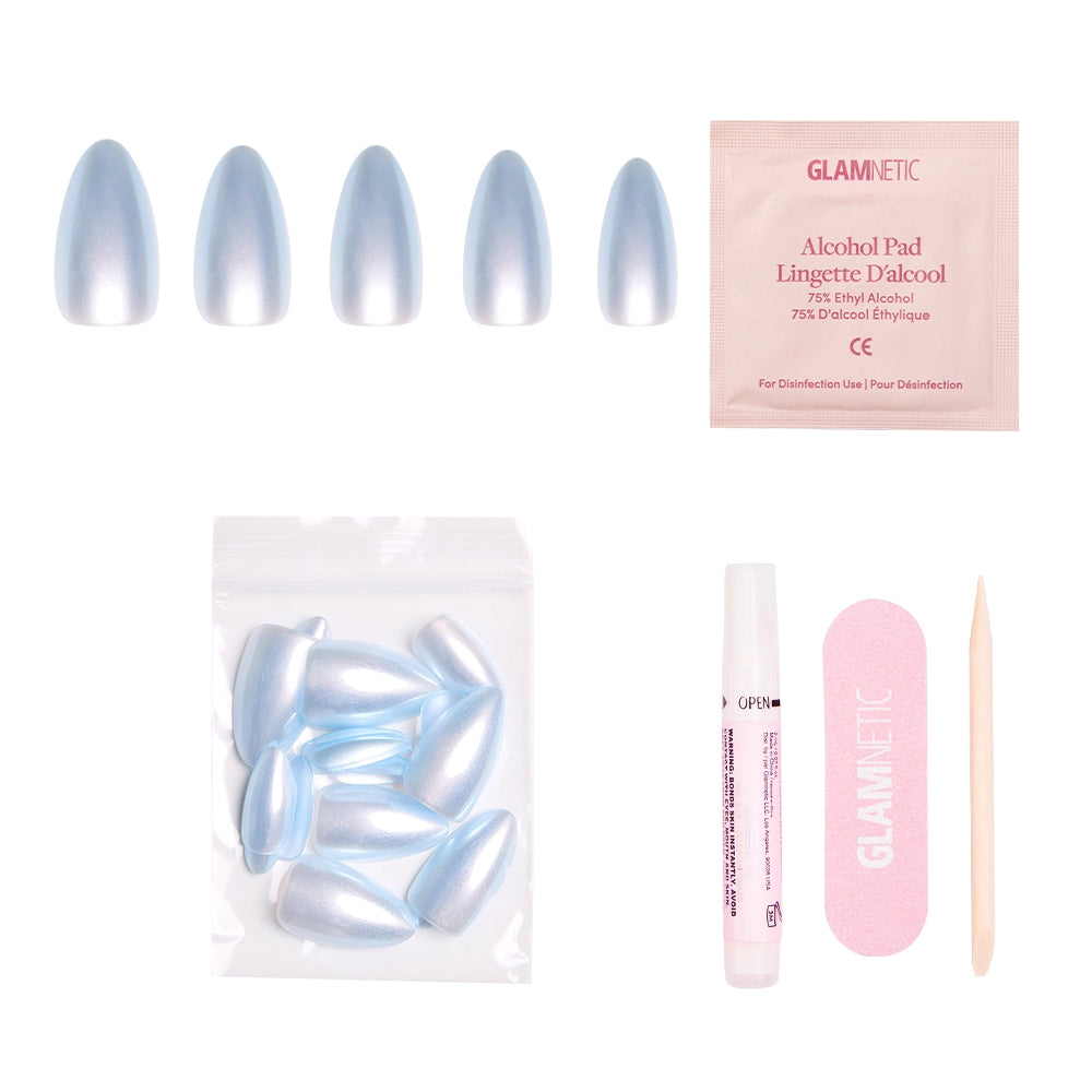 The glamnetic Something Blue press-on nail kit features salon-quality baby blue short almond nails, extra nails, nail glue, an alcohol pad, a pink nail file, and a wooden cuticle stick—all displayed on a white background. - Product image
