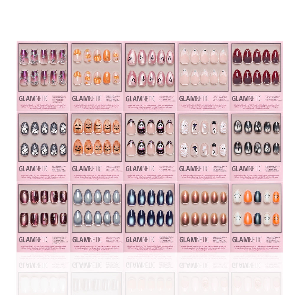 Sixteen sets from the glamnetic Spells & Sparkles Collection are showcased in pink trays, each featuring distinct designs—including a Halloween-themed set with skulls and pumpkins, along with animal motifs and a variety of vibrant colors—arranged in four tidy rows on a white background. These salon-quality press-on nails celebrate creativity and style for any occasion. - Product image