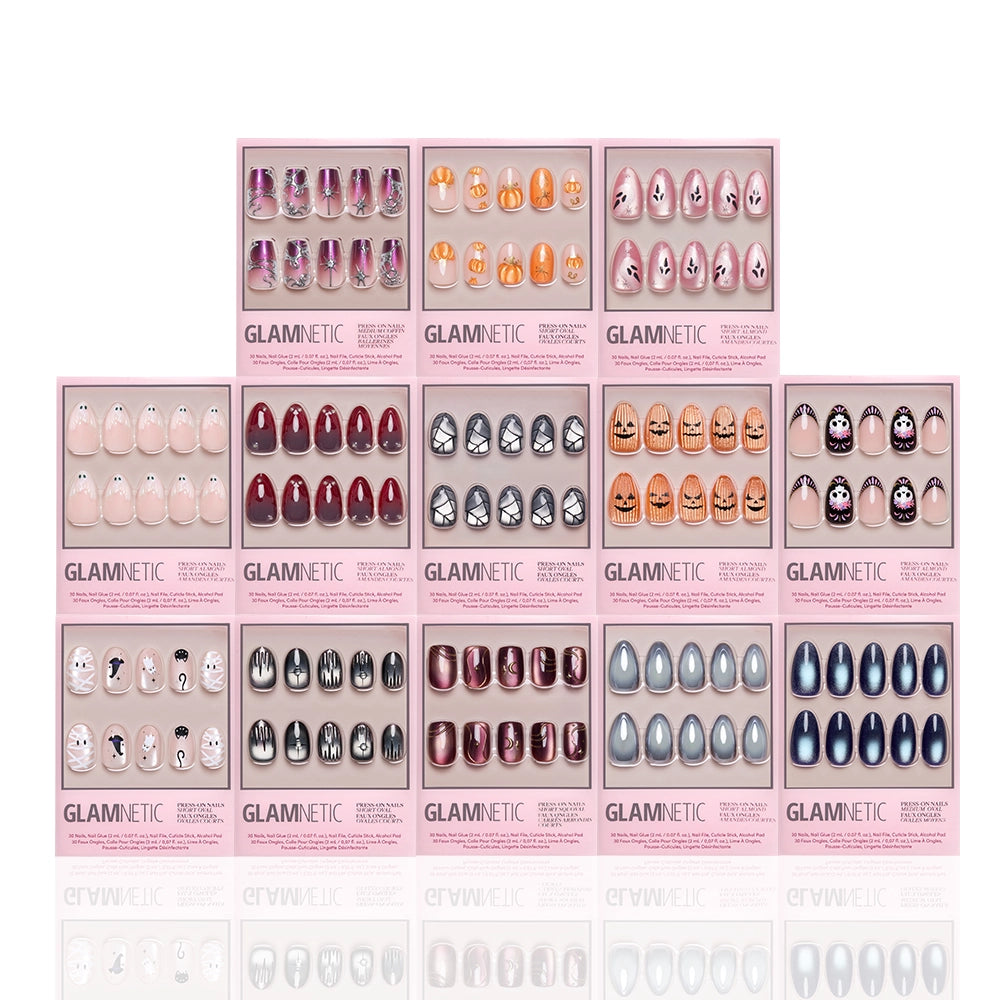 Fourteen boxes of glamnetic’s Spells & Sparkles: The Glue-On Grimoire press-on nail sets, each featuring a unique nail design and color—including patterns such as animal faces, ombre, glitter, hearts, and solid hues—are neatly arranged in a grid on a white background. These salon-quality glue-on nails showcase both style and durability. - Product image