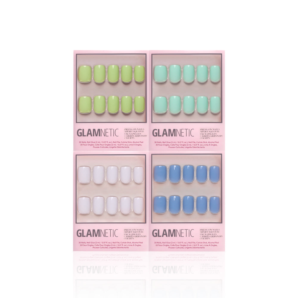 Four boxes of glamnetic Spring Showers short squoval press-on nails are shown in a grid, each with pastel green, teal, white, and blue shades in glossy pink packaging featuring the brand name. - Product image