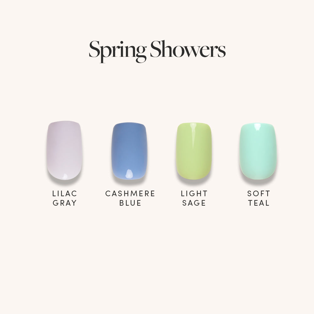 The Spring Showers set by glamnetic features four short squoval press-on nails in Lilac Gray, Cashmere Blue, Light Sage, and Soft Teal, each with a chic glossy finish.