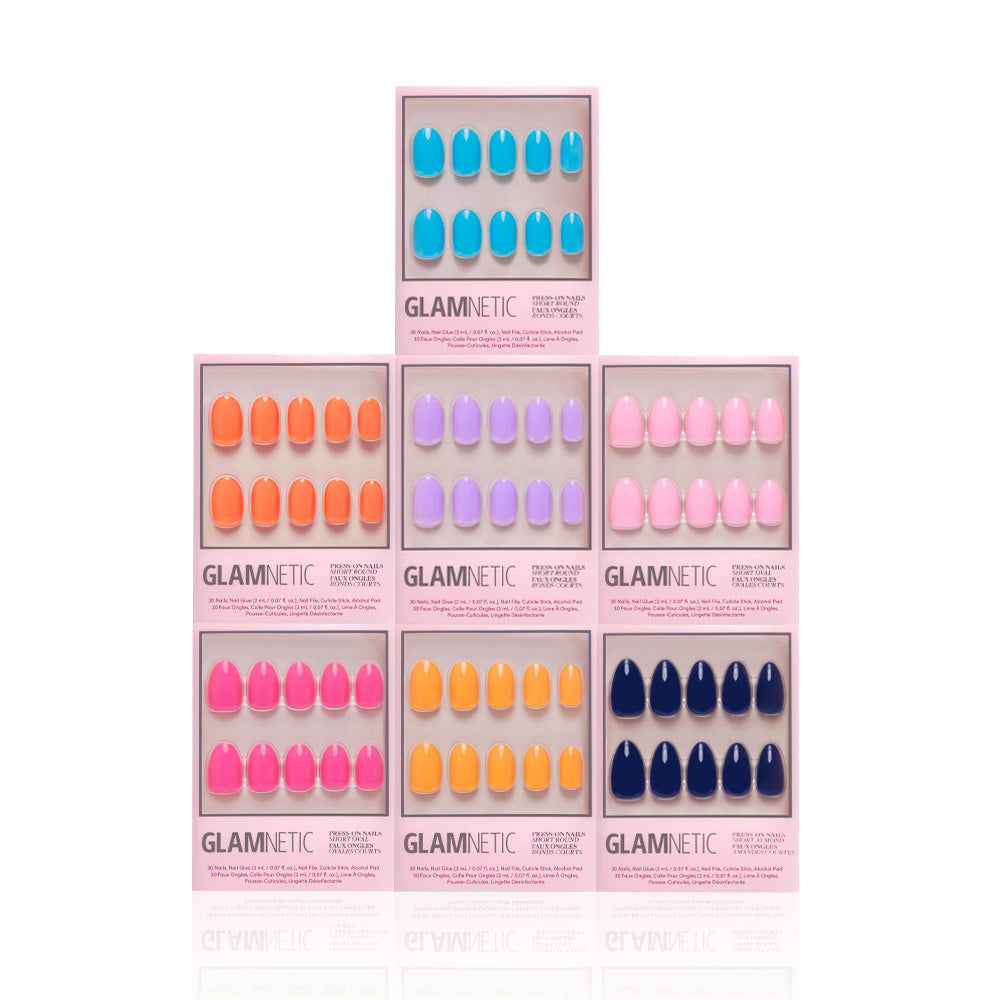 Seven sets of glamnetic Spring Sunset oval press-on nails, glossy and bright, are arranged in a pyramid stack. Each set is in a rectangular box on a white background. - Product image