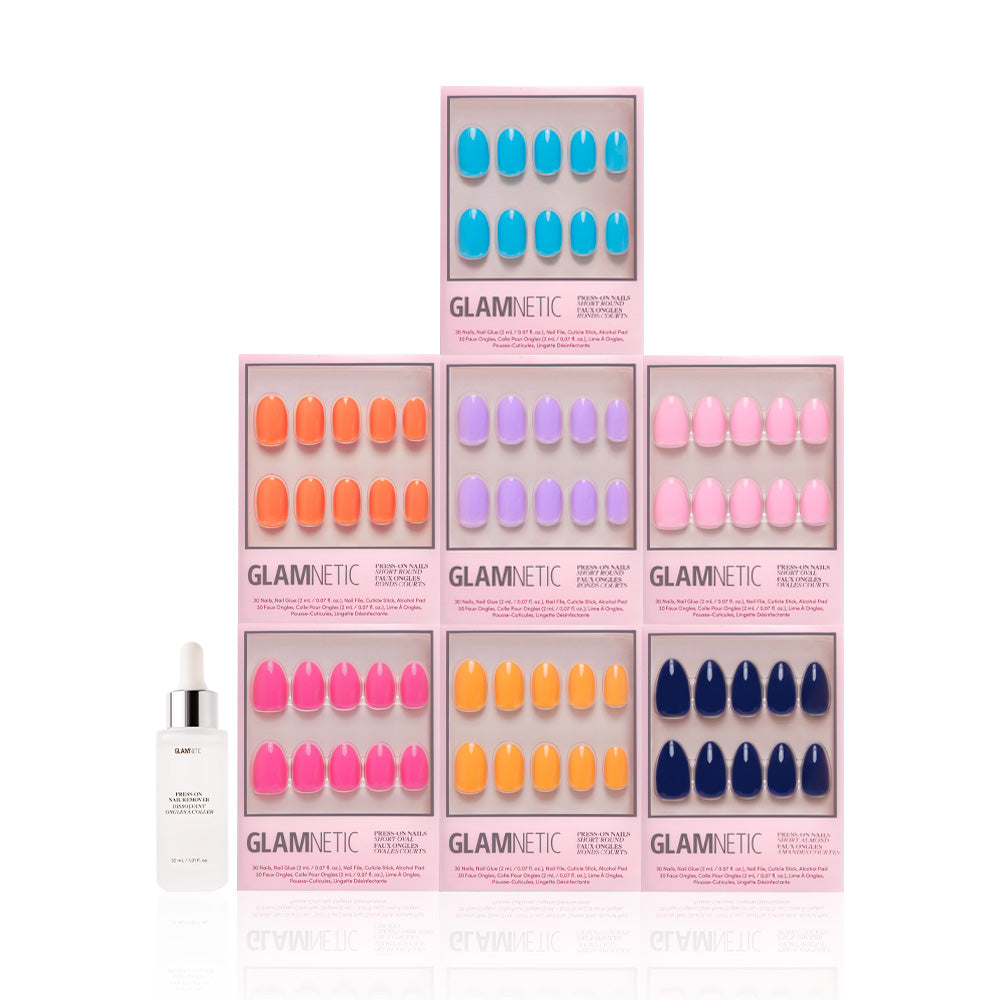 Seven boxes of glamnetic Spring Sunset press-on nails, each with a glossy finish, are stacked in a pyramid. In front is a white dropper bottle labeled glamnetic, all set against a clean white background. - Product image