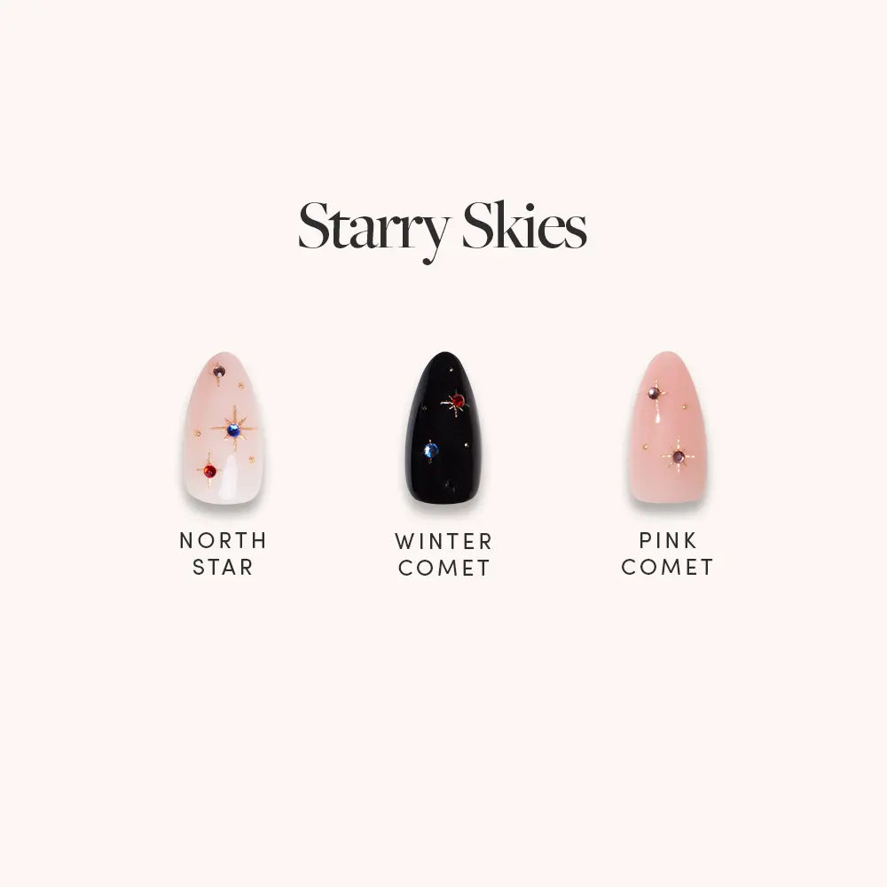 Glamnetic’s “Starry Skies” set features three chic short almond artificial nails with gold foil stars and comet designs on nude, black, and pink backgrounds, sparkling under the “Starry Skies” label.