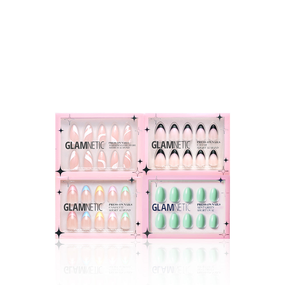 Four sets of glamnetic’s Summer Picnic Collection press-on nails in pink packaging—featuring light pink, black and nude, iridescent pastel, and solid green designs—are displayed on a white background. These nails are vegan and cruelty-free for easy chic style. - Product image