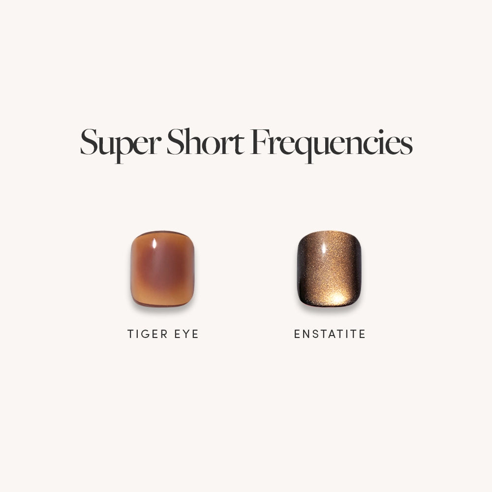Two polished gemstones labeled “Tiger Eye” and “Enstatite” appear under the title "Super Short Frequencies" by glamnetic, evoking gemstone-inspired manis as vibrant as super short press-on nails, all set against a light background.