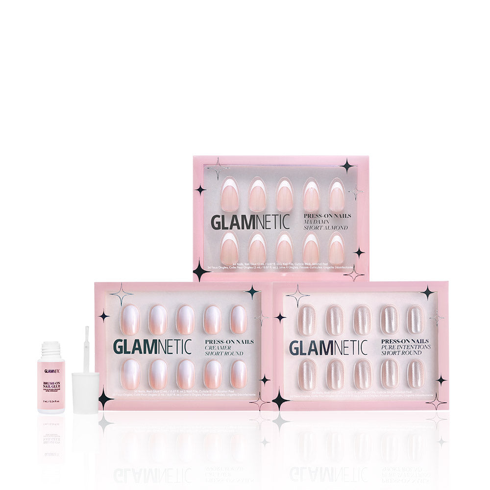 Three boxes of glamnetic Sweater Weather press-on nails are stacked with an open nail glue and brush beside them. The pink and black starry packaging pairs perfectly with the Press On Nail Remover for easy removal. - Product image