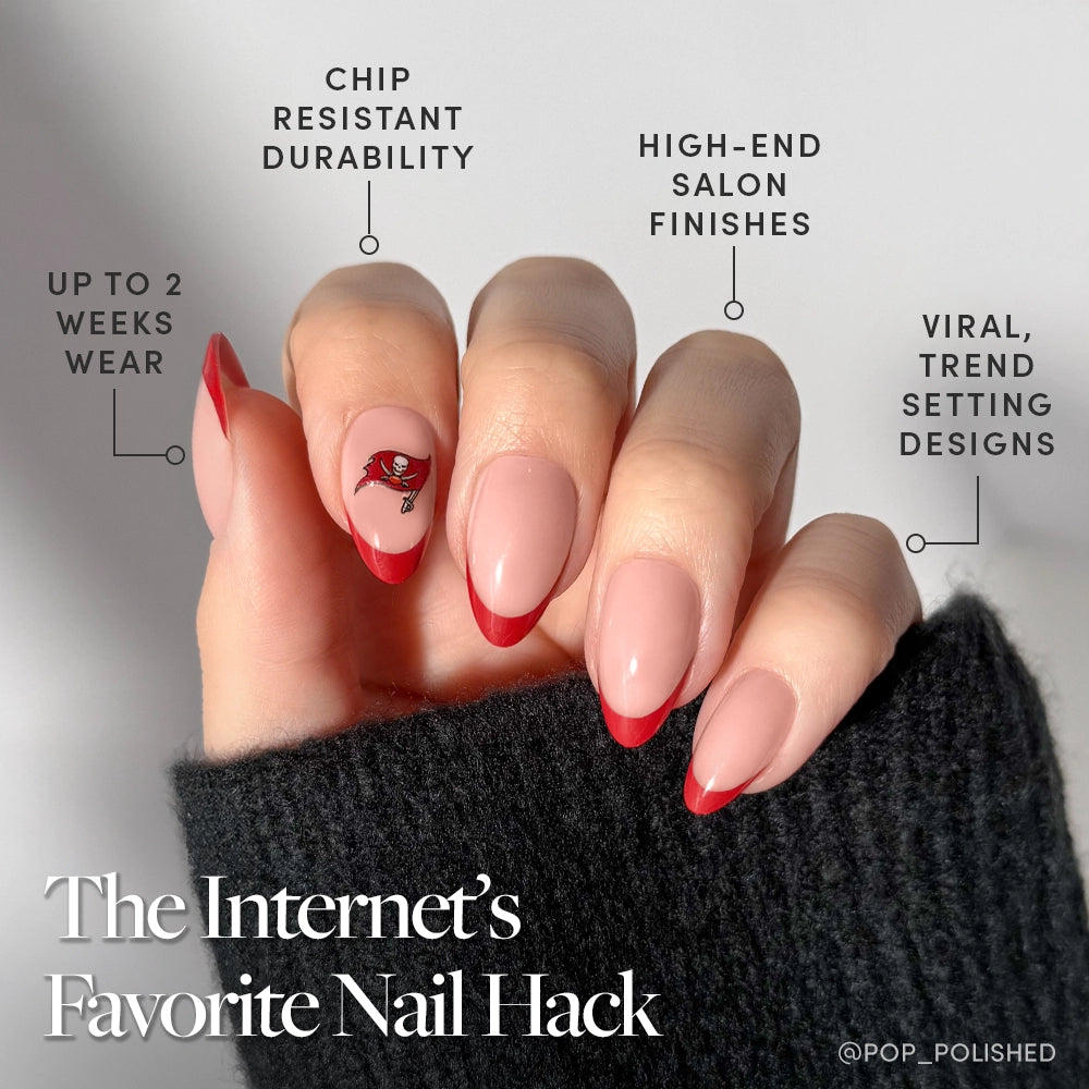 Show off your Tampa Bay Buccaneers pride with glamnetic’s Press-On Nail Set—almond-shaped nails featuring glossy red French tips, a floral accent, and pale pink polish. Enjoy up to 2 weeks’ chip-resistant wear and on-trend, high-end finishes!. - Product image