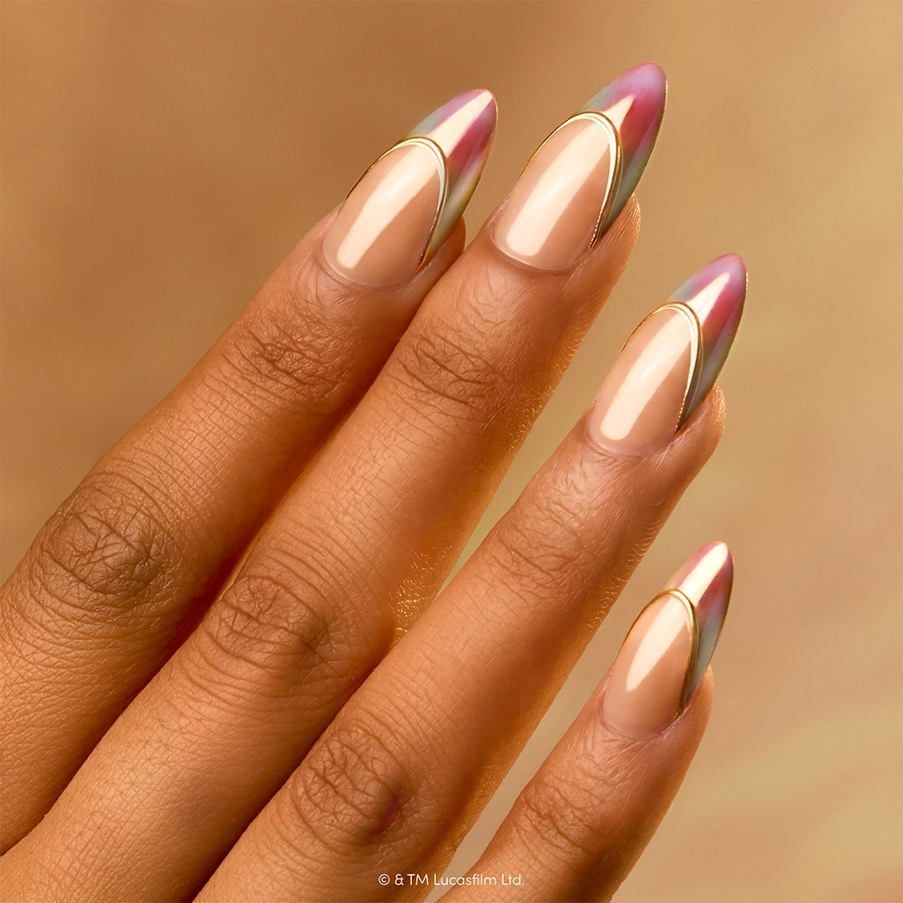 The Jedi Order - A hand with long, almond-shaped nails featuring glamnetic’s The Jedi Order press-on set—a shiny, metallic pink and silver tip design with gold accents on a nude base—delivers an effortlessly chic and glamorous look.