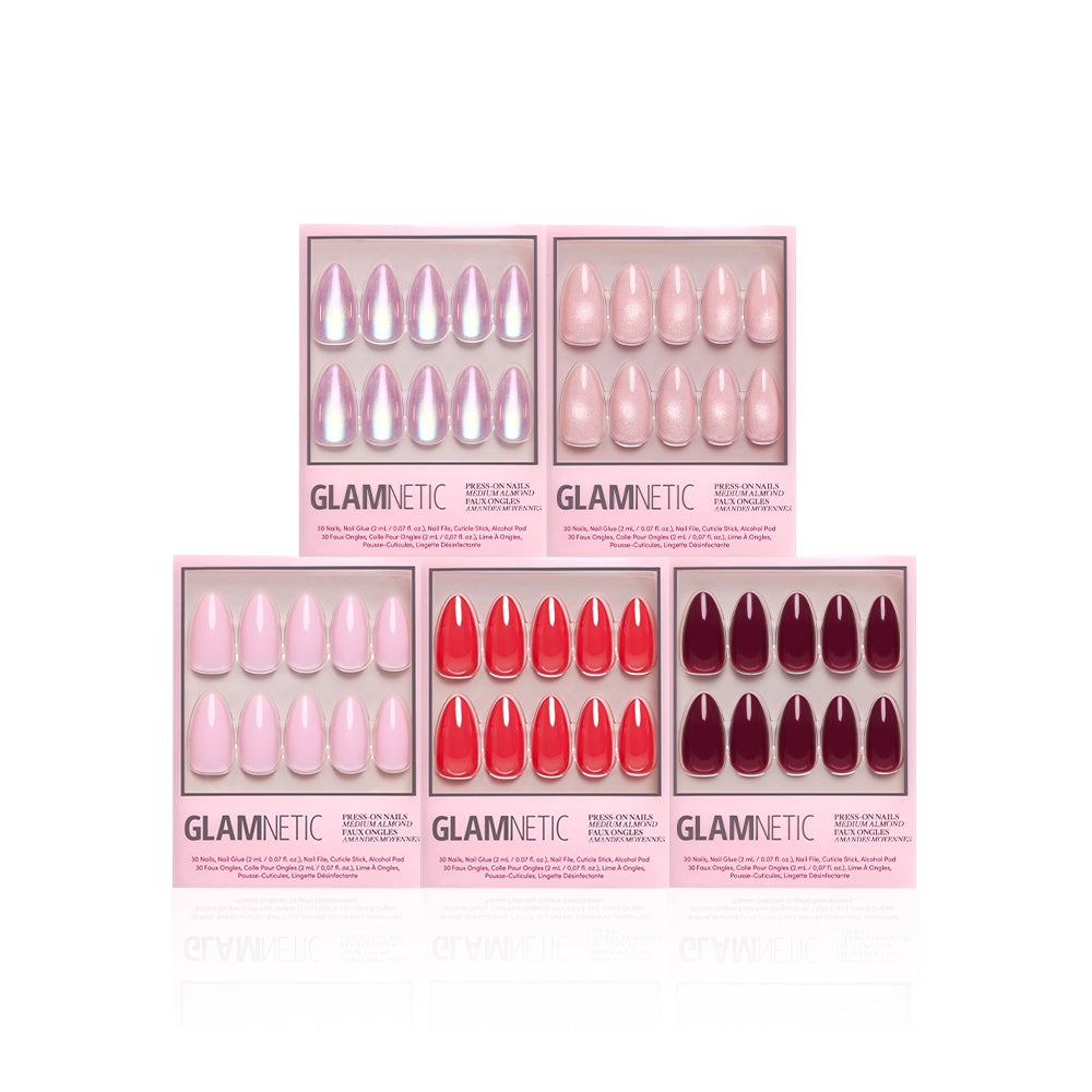 Five boxes of glamnetic’s The Medium Almond Edit are arranged in a pyramid. This manicure bundle includes medium almond nails in light pink, nude, coral, red, and burgundy shades, all in sleek pink packaging.