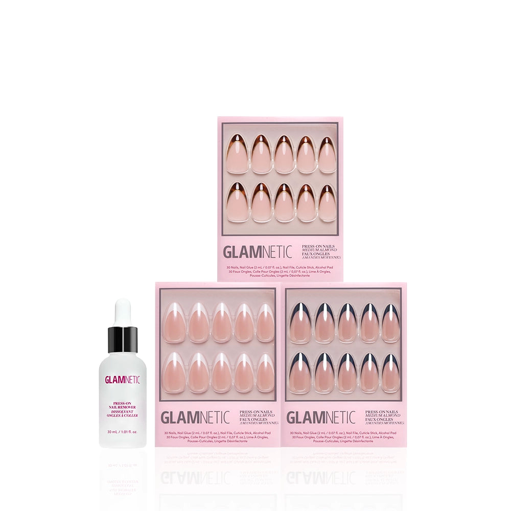 Three pink boxes of glamnetic The Medium Almond Frenchies press-on nails are stacked in a pyramid, next to a small bottle of glamnetic nail glue with a white dropper cap, all set against a white background. - Product image