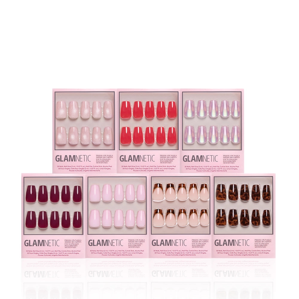 Seven boxes of glamnetic’s The Medium Coffin Edit press-on nails in assorted pink, red, iridescent, nude, and dark shades create the perfect mani wardrobe and are arranged in two rows against a white background. - Product image