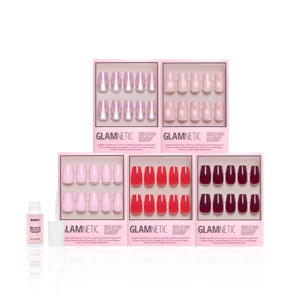 Six boxes of glamnetic's The Medium Coffin Edit press-on nails in pink, red, and burgundy are arranged in two rows with a small open bottle of nail glue on the left, all set against a white background for a vibrant manicure bundle. - Product image
