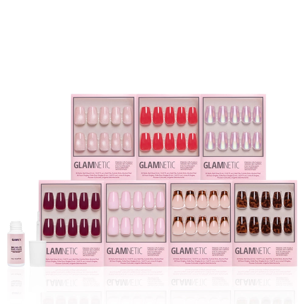 Seven boxes of glamnetic’s The Medium Coffin Edit press-on nails in various shades are arranged in two rows, alongside a nail glue bottle—offering a chic, sculpted set to elevate your mani game. - Product image