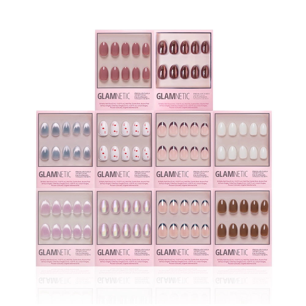 Ten boxes of glamnetic’s The Oval Vault press-on nail sets are stacked in a pyramid, showcasing solid colors, French tips, ombré styles, and polka dots in pink packaging—a must-have limited-edition nail bundle. - Product image