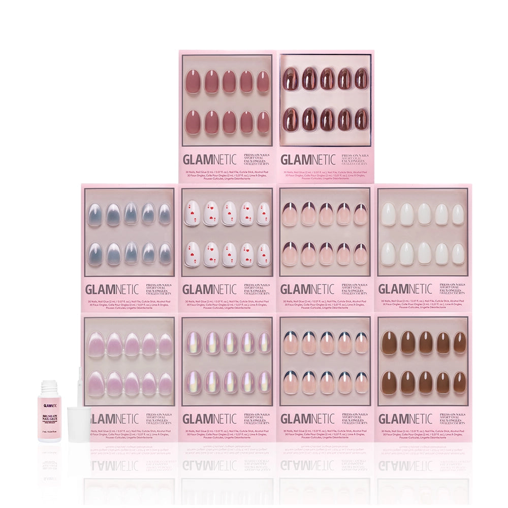 Introducing The Oval Vault by glamnetic: a limited-edition bundle with twelve press-on nail sets in nude, pink, and brown shades—including short oval nails—featuring polka dot and white designs. Includes a small bottle of nail glue. - Product image