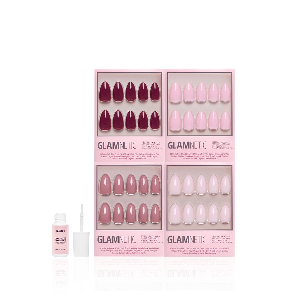 Four sets of glamnetic The Pink Short Almond Icons press-on nails in pink and mauve shades are displayed in branded pink boxes. A nail glue bottle with brush sits in front, all shown on a white background. - Product image