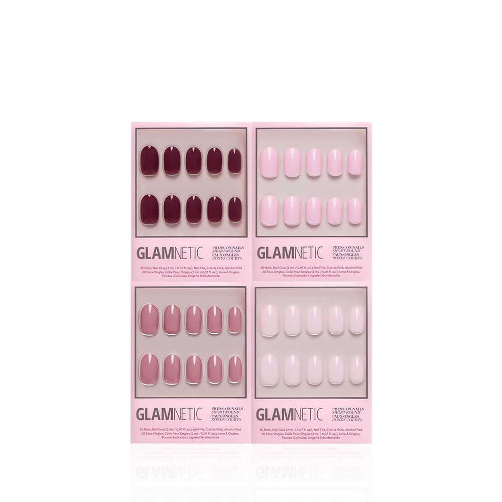 Four boxes of glamnetic's The Pink Short Round Icons are displayed in a grid on a white background. Each box contains ten short round nails in different solid shades of pink and mauve. - Product image
