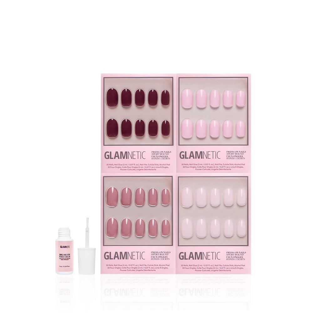 Four boxes of glamnetic’s The Pink Short Round Icons nails in glossy pink and mauve are displayed, with a small open nail glue bottle and applicator brush in front. - Product image