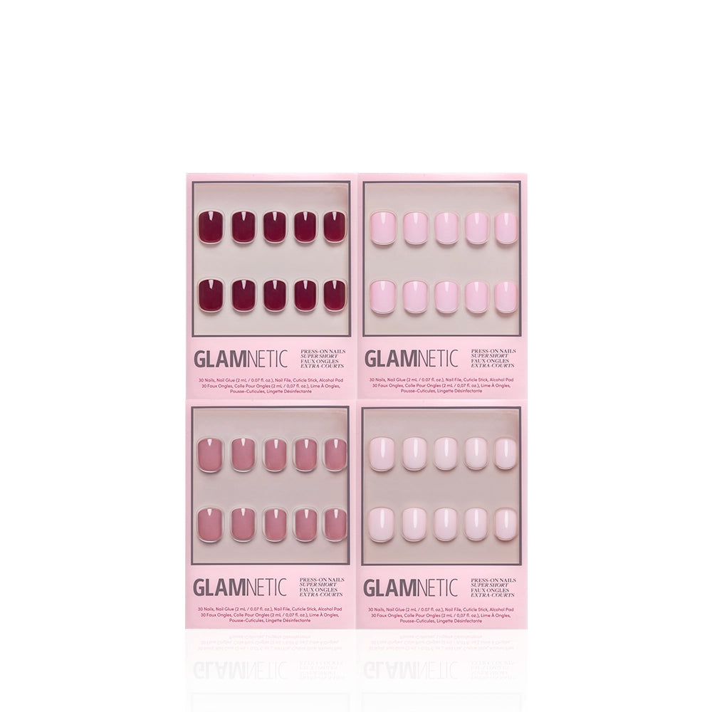 Four boxes of glamnetic's The Pink Super Short Icons press-on nails are arranged in a square. Each box displays shiny shades of red, pink, mauve, and blush against a white background. - Product image