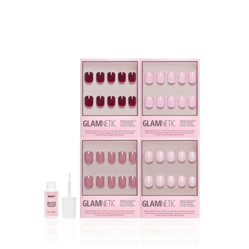Four sets of glamnetic's The Pink Super Short Icons, featuring glossy mauve and blush tones, are displayed in branded boxes. A nail glue bottle with an open cap is to the left, highlighting these stunning pink press-on nails against a white background. - Product image