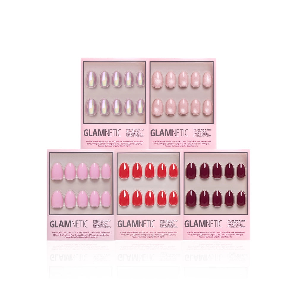 Glamnetic's The Short Oval Edit features six press-on nail sets in pink, red, and nude shades, arranged in two rows—a chic mani collection displayed on a white background.