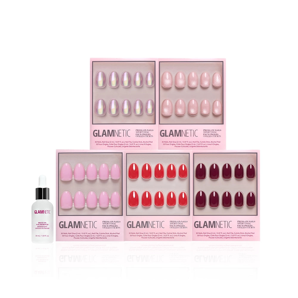 Six boxes of glamnetic's The Short Oval Edit, featuring pink and red press-on nails, are arranged in two rows. A glamnetic cuticle oil bottle with dropper sits at the front left, completing your mani wardrobe. - Product image